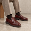 The Valenor Handcrafted Burgundy Leather Brogue Detailing, Refined Moc-Toe Silhouette & Polished Heritage Finish Penny Loafers